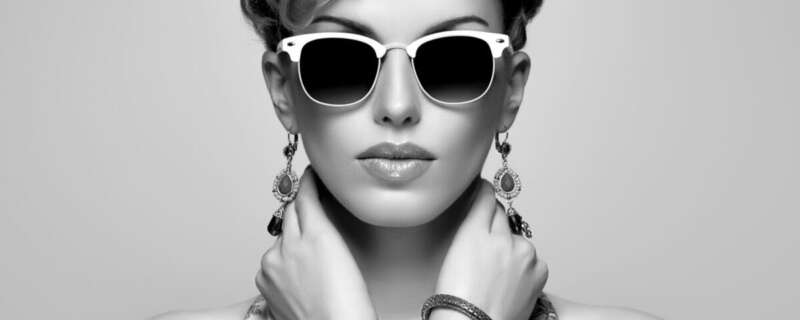 Fashion Portrait Model in Sexy Dress. Stylish Mohawk hairstyle,fashion Makeup. Beauty woman in Trendy Sunglasses, Glamour Lady,fashion pose. Playful Girl,Luxury summer Accessories.Black and white